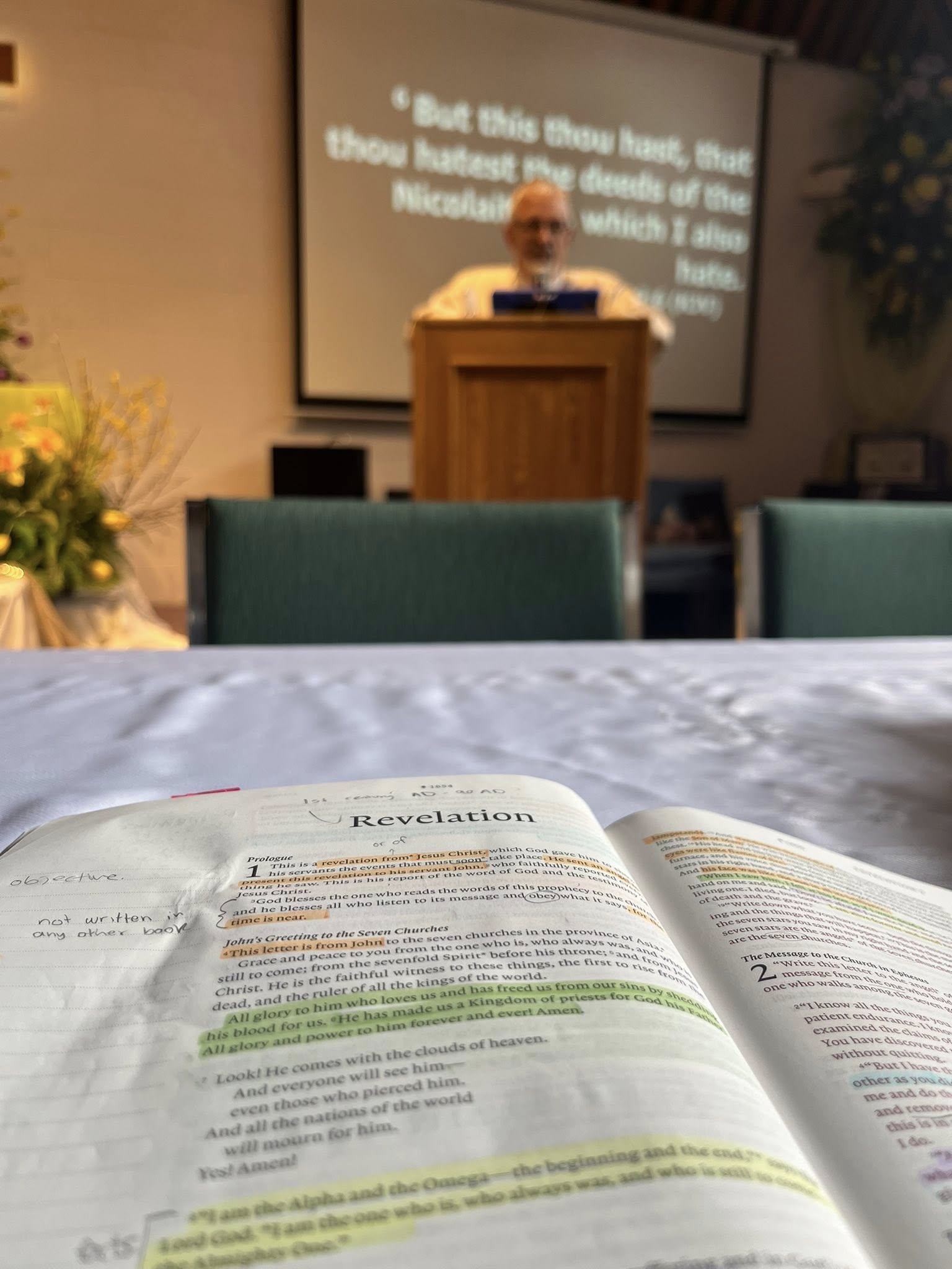 Bible education session with congregation families studying the Scriptures together in a warm group setting